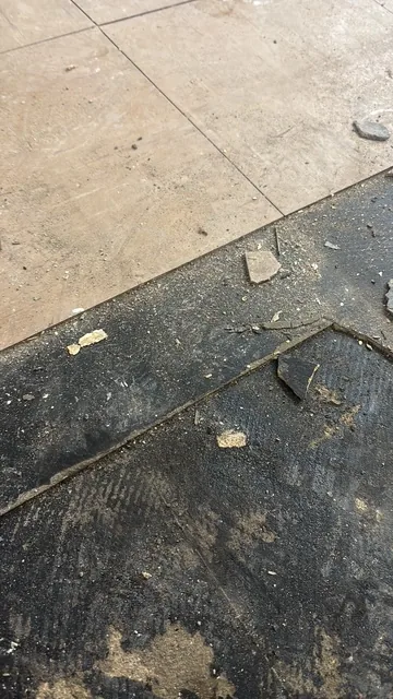 Black bitumen mastic floor removal in a W5 flat